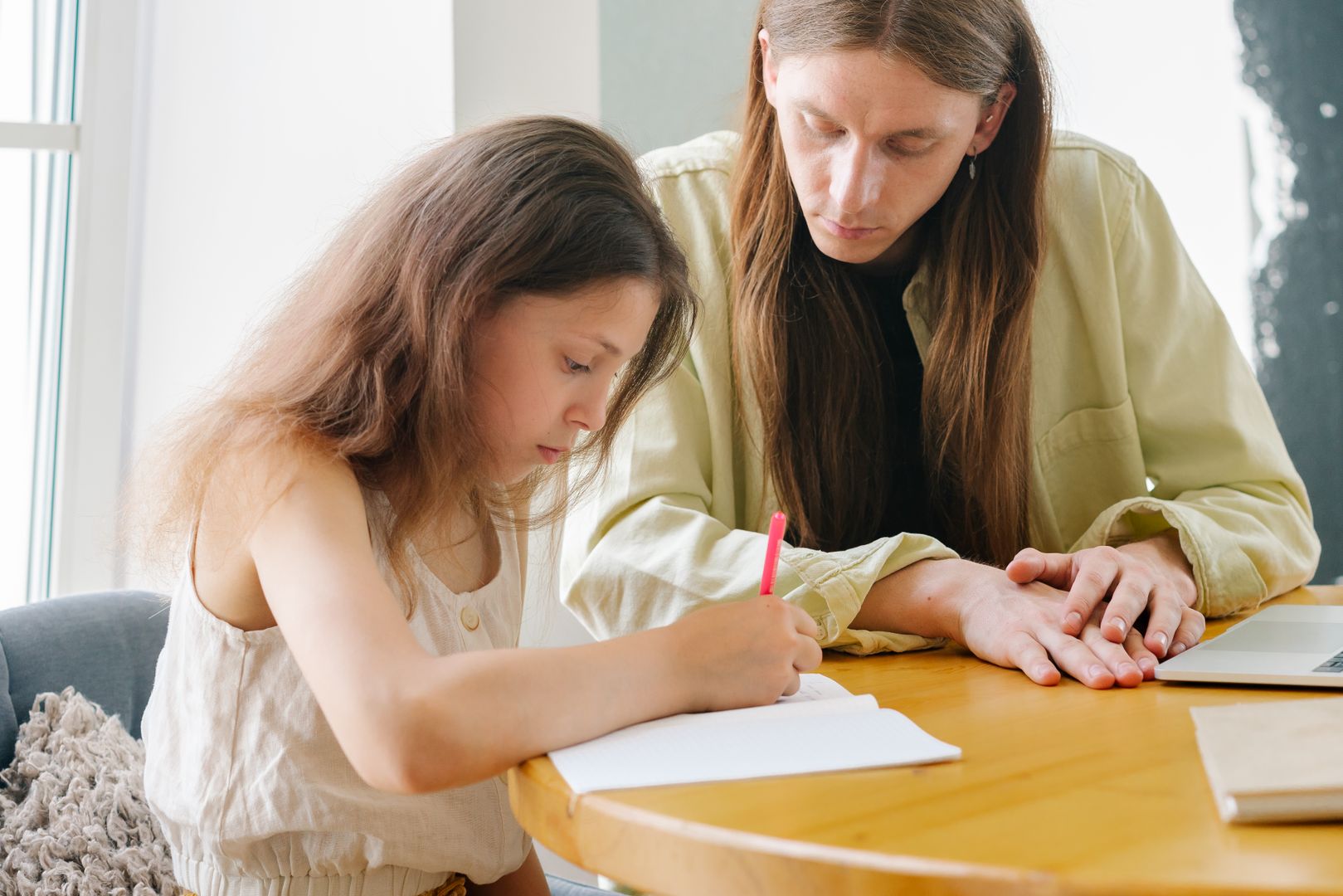 A child writes a practice text with concentration