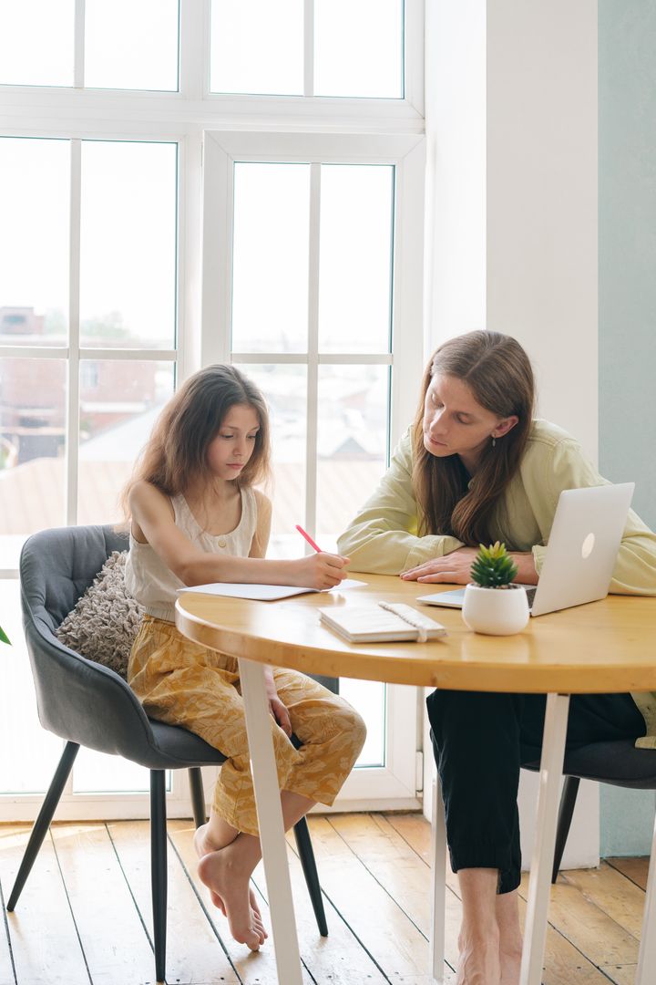 A parent supports a child while studying
