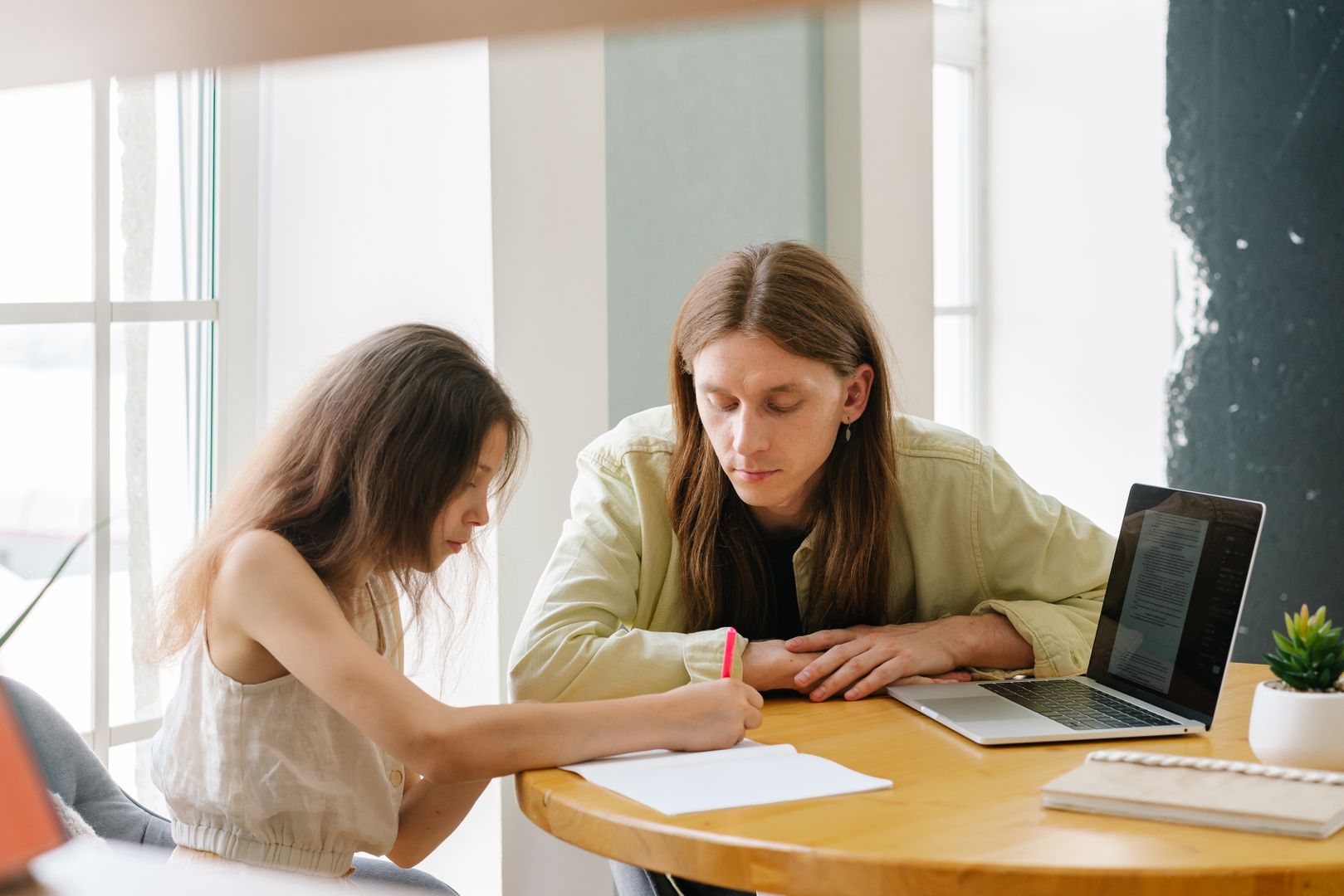 A parent and child review the written text together